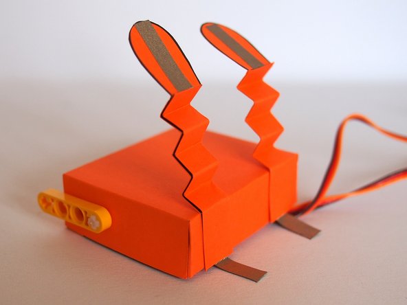 Glue the legs to the bottom of the body.