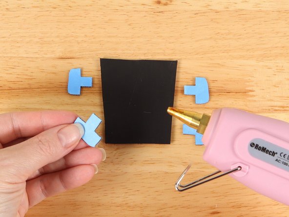 Using hot glue or another strong glue, attach the tuning pins to the head.