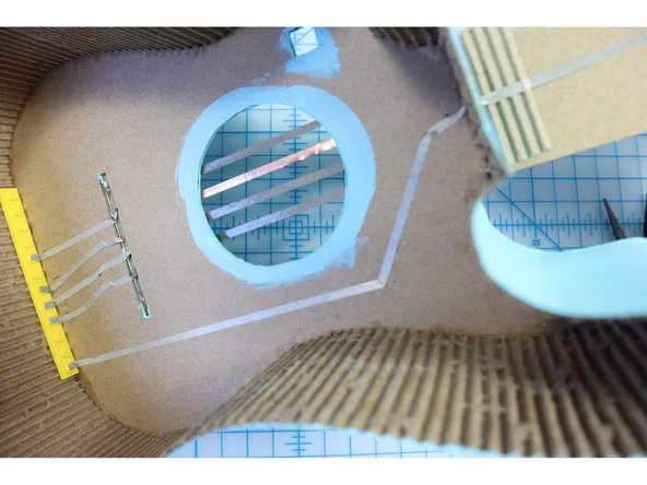 Continue the ground connection down the back of the neck to the Bit Board by placing a hole in the wall as shown.