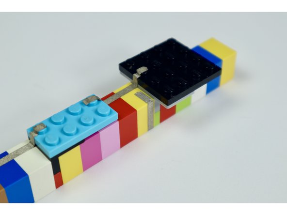 Starting with photo 1 and ending with the photos in the next guide step, measure, cut peel and stick the remaining 4 tape paths where shown.