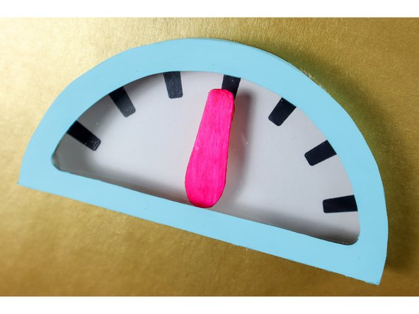 Glue the box on top of the dial face with hot glue.