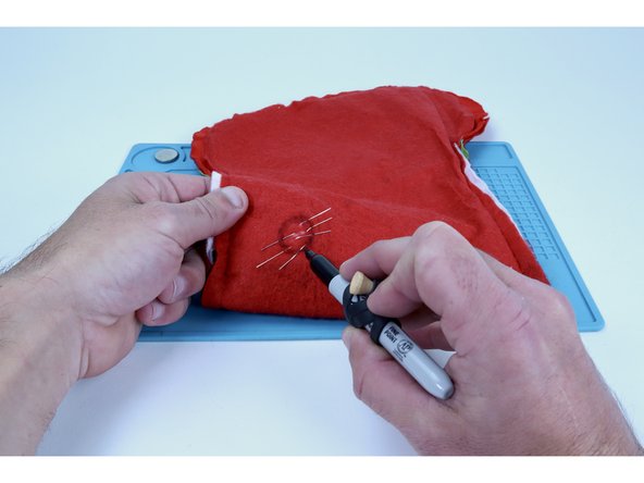 Hot glue is an excellent insulator and the points at which the legs of the 3 LEDs all enter/exit the fabric are very close together. In the next guide step we will be putting a blob of hot glue near the center of the cluster after we make sure the legs are not touching to hold them in that position.