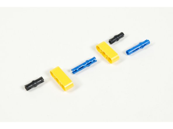To connect the larger beams we'll build a small connector using two 3 hole beams, two long (blue) pins, and two regular (black) pins.