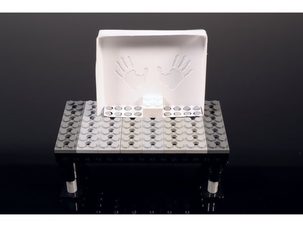 Use a single 2x2 LEGO brick to secure the shadowbox in place.