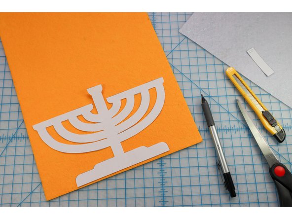 Trace the menorah shape onto the backside of the gold felt.