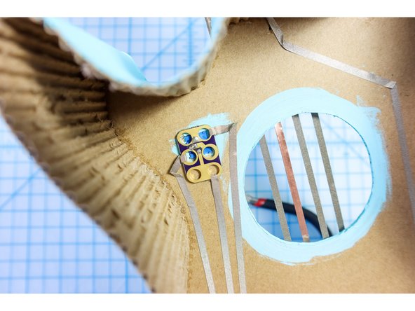 Place the potentiometer in its place inside the square hole in the cardboard.