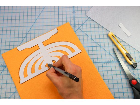 Trace the menorah shape onto the backside of the gold felt.