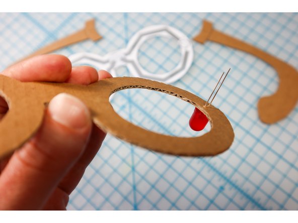 Push the LEDs through the holes on the frames, with the Positive (Long Leg) facing away from the center.