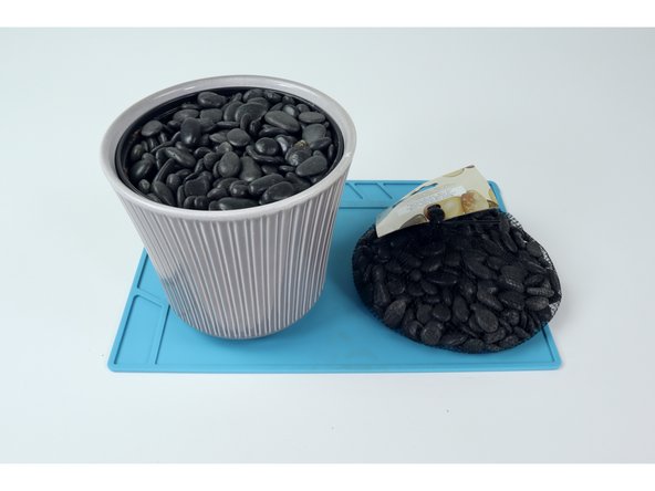 To prepare the flower pot we chose to dump the dirt and refill with stones so it would be less messy... but dirt works just fine.