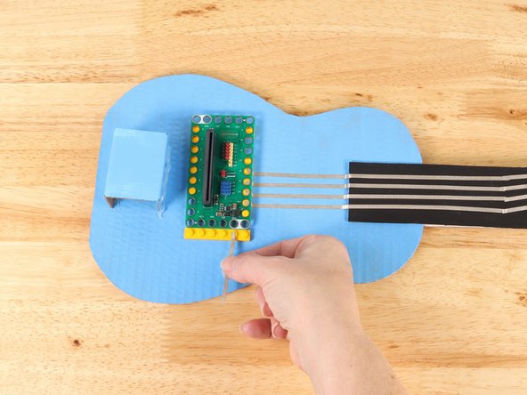 Remove the Bit Board and start a path of Maker Tape from one of the white (ground) holes.