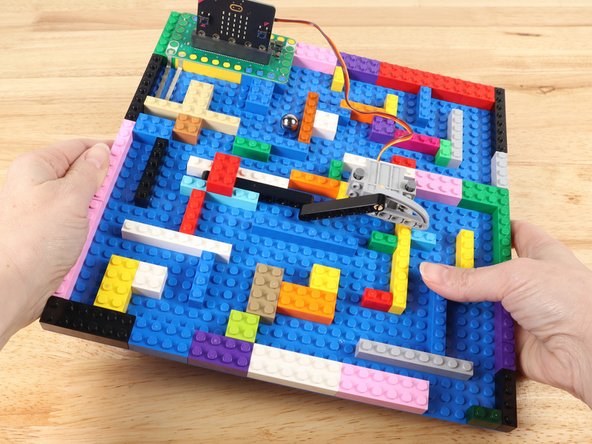 Tilt the LEGO baseplate to roll the ball bearing through the maze.