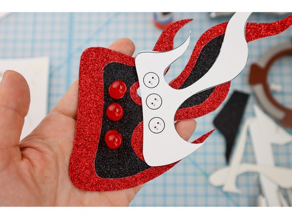 Use a push pin to poke holes for the LED legs to push through as shown.