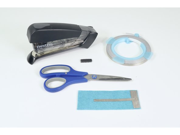 Gather the materials shown: Stapler/Staples, Scissors, 1/4&quot; MakerTape and your Conductive Hook &amp; Loop material.