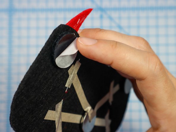 Then, peel the paper backing off of the other side and stick the design to the hat.