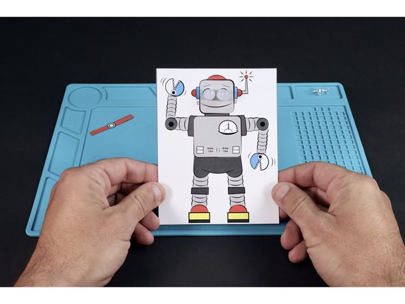Each vertical column of dots is a place to feed a single LEDs legs through. Feed the legs of each of the LEDs through their pair of holes from the front. Make sure to feed the short legs through the topmost holes and the longer legs through the lower holes.