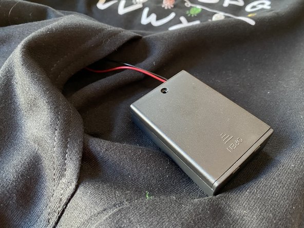 Insert the battery pack wires into the power connector with a small screw driver.