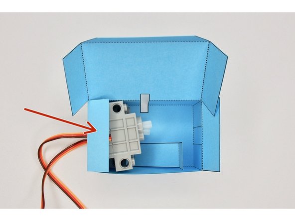 Fold the left-hand tab on top of the servos.