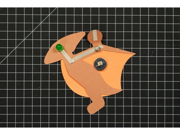 Since Maker Tape is conductive on both sides you can use it to make a tape loop that helps hold your battery in place.