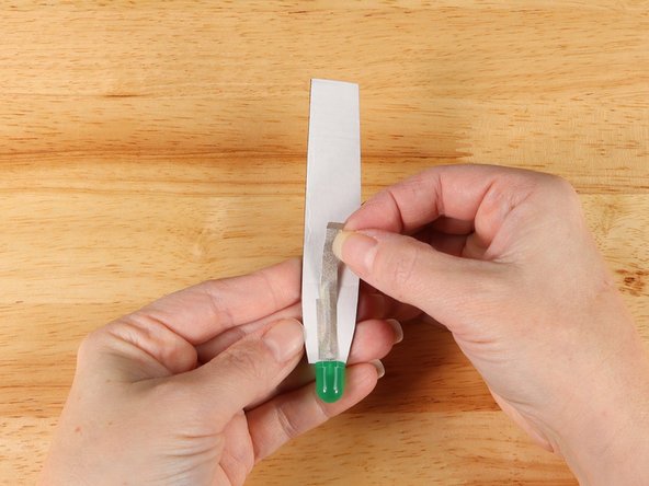 Flip the handle over and add a small strip of Maker Tape on top of the LED leg.
