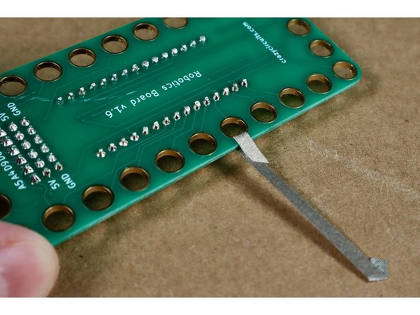 Go through the hole and wrap the tape around to itself.