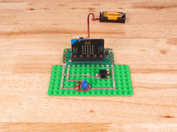 The Piezo will connect to Pin 8 and to Ground (GND) BUT! We're going to use the &quot;gutter&quot; between the LEGO baseplate studs so we can have two layers of tape that do not touch.