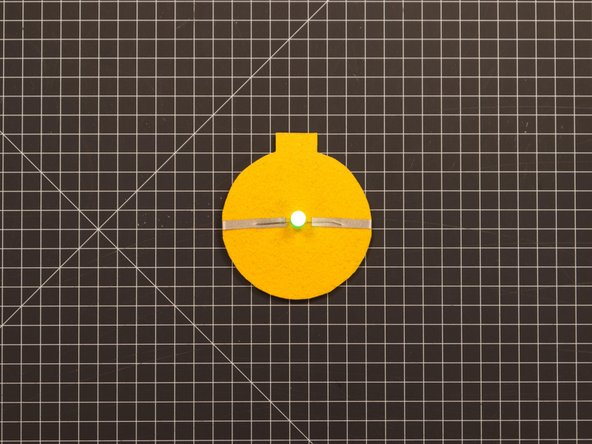 If you left the positive piece of Maker Tape touching the battery on the back your LED should be lit up. If you disconnected the tape (acting as a switch) the LED should be off.