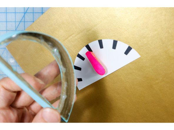 Glue the box on top of the dial face with hot glue.