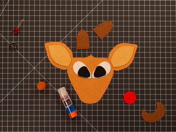 For the eyes you'll need to glue the smaller piece (black felt) to the larger piece (white felt) and then attach them to the face.