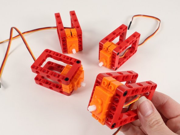 Continue adding red frames until all 4 servos have two red frames on the black pins.