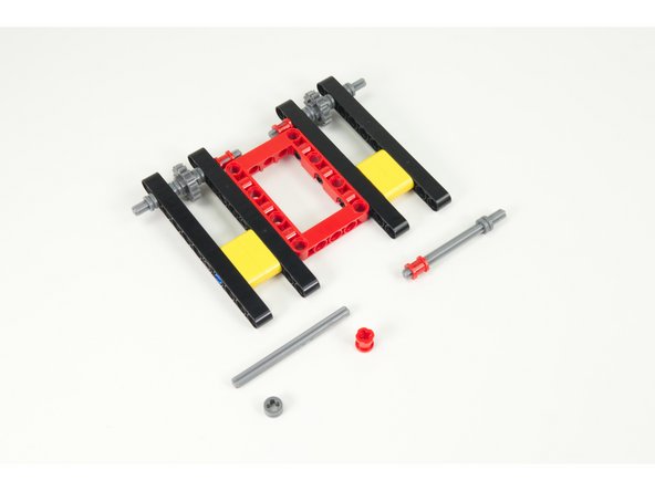 Next we'll add the rear axles. Get two more axles, two more half-size bushings, and two more full size bushings.