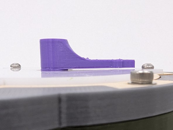 Press the motor arm on top of the motor shaft in the center of the acrylic diffuser.  You may need to use a bit of force to press fit the arm onto the shaft.  It should be a snug fit.