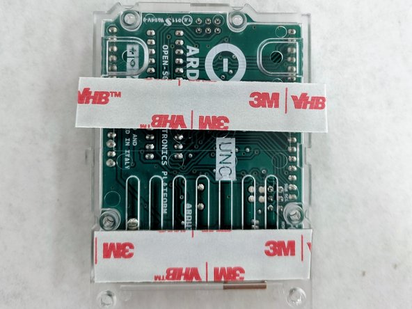 Apply two strips of the wide VHB tape to the back plastic sled which houses the Arduino.