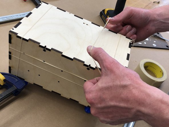 If you have used clamps, remove them.   Rubber band the box along all axes, using at one or two rubber bands per direction.