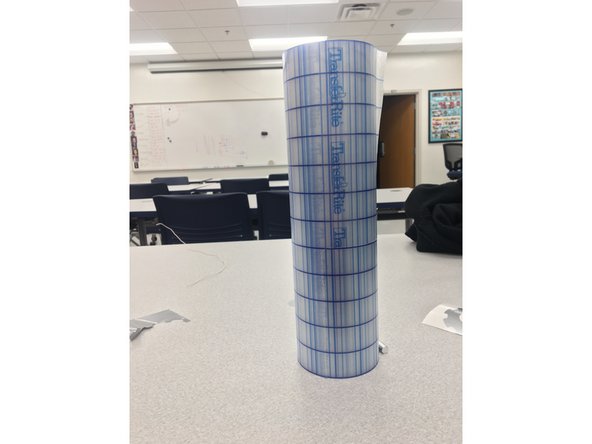 Pick up a roll of transfer tape from the same place the vinyl is stored. The transfer tape will allow you to transfer your sticker from the backing material to where you want to adhere it.