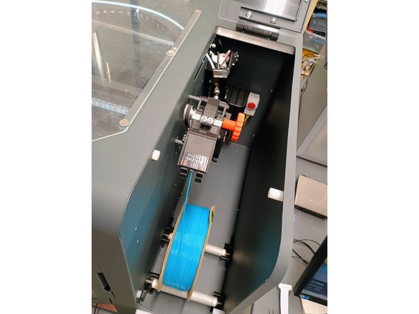 Take the end of the filament out of the holes that secured it.