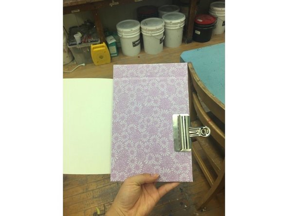 Clip the covers and paper with a binder to keep it in place for drilling.