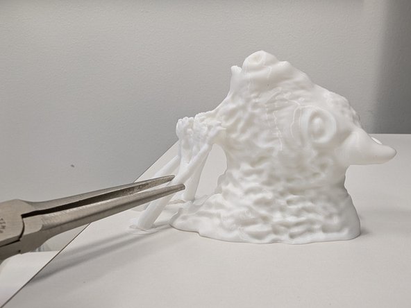 If your part had support material you should be able to remove it using your fingers.  Sometimes a pair of needlenose pliers are helpful as well.