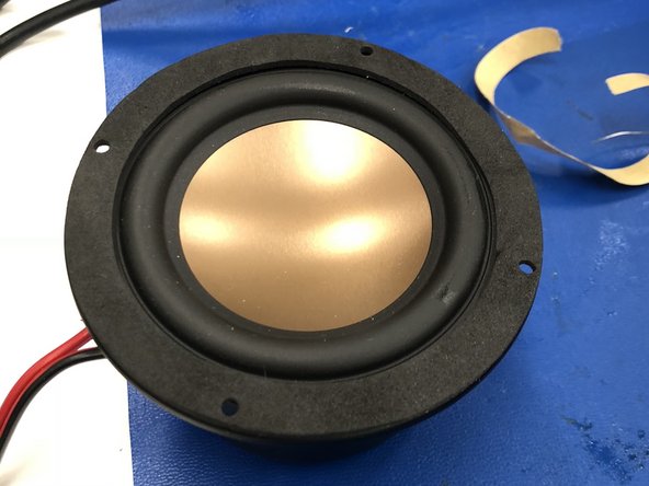 Attach the rubber gasket to the lip of the speaker, taking care that the screw holes align.