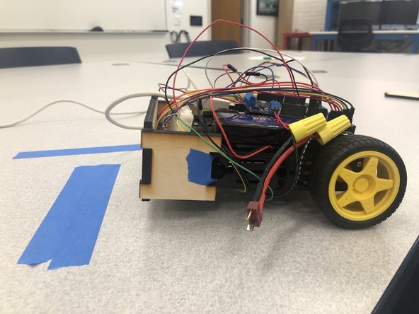 Plug in the LiPo battery to the robot and while the connected LED is blinking slowly, place the photoresistors attached to the breadboard and cart over a white surface.