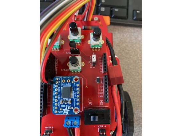 The temperature sensor can be inserted directly into the 3-pin header with the flat of the sensor facing the back of the robot.