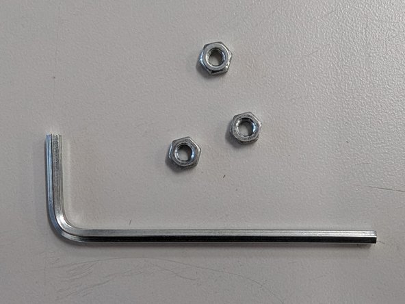 Locate the three hex nuts and the larger of the two provided hex keys.