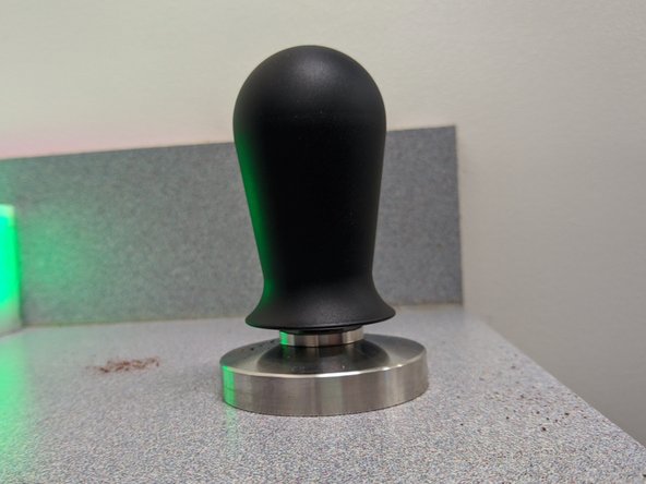 Once the grounds are evenly distributed and roughly level, grab the tamper.  Lay it on top of the grounds.