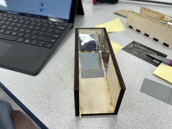 Once the box is dry, stick the mirrors on the inside of the box as shown.