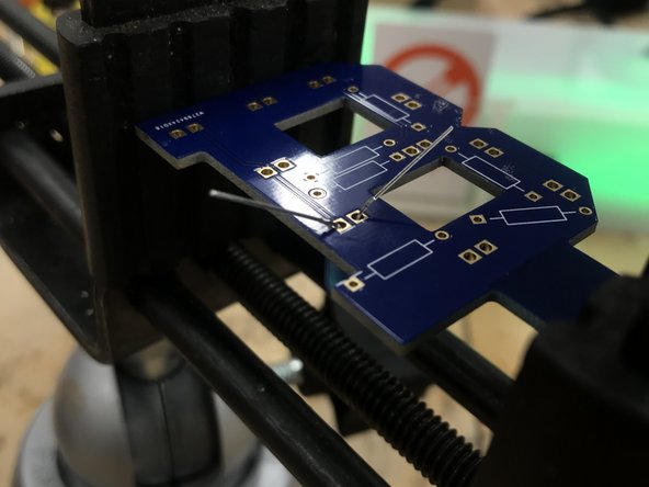 Flip the board over and bend the legs slightly to prevent the component from falling out.