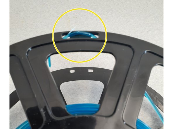 Remove the spool of filament from the holder.