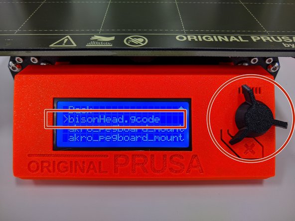 With the SD card loaded you will be presented with a list of gcode files on the LCD.  Use the black knob to rotate the indicator arrow until your file is selected.  In this case we are printing bisonHead.gcode.  Press the scroll knob to select the file.