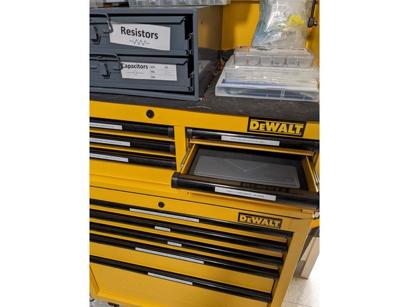 If you cannot locate scrap material that will work for your design, you may use new stock material located on the shelf next to the half wall. If none of the desired material is on the shelf, check the shelf in the stock room.