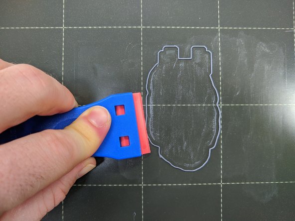 Remove any remaining plastic from the print bed by using the plastic scraper.  The printer will print a skirt, a small ring of plastic, around the perimeter of your part.  Be sure to remove this skirt.