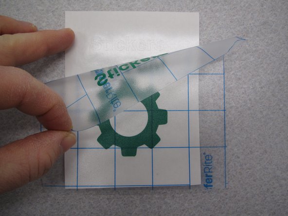 Peel back a corner of the transfer tape and remove the sticker from the backing material.  Pay attention to small shapes and fine detail in your sticker to make sure they are removed properly.