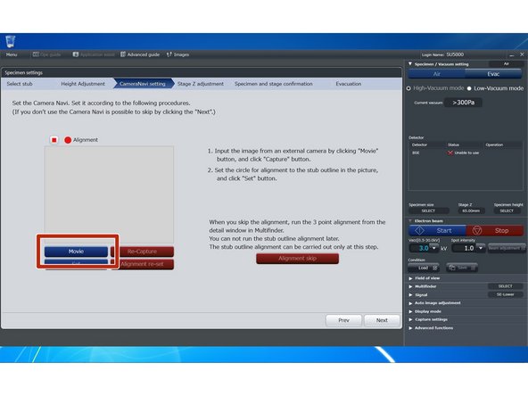 Insert the specimen holder assembly into the NaviCam so that the mount is snug against the stop bar. Turn on the Navicam light.